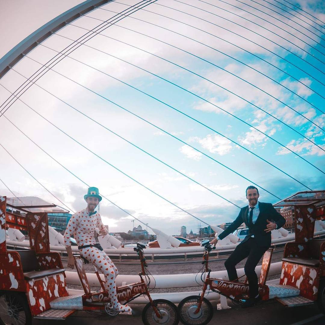 Ludo as Loveman with a friend, two heart pedicabs on a Dublin bridge