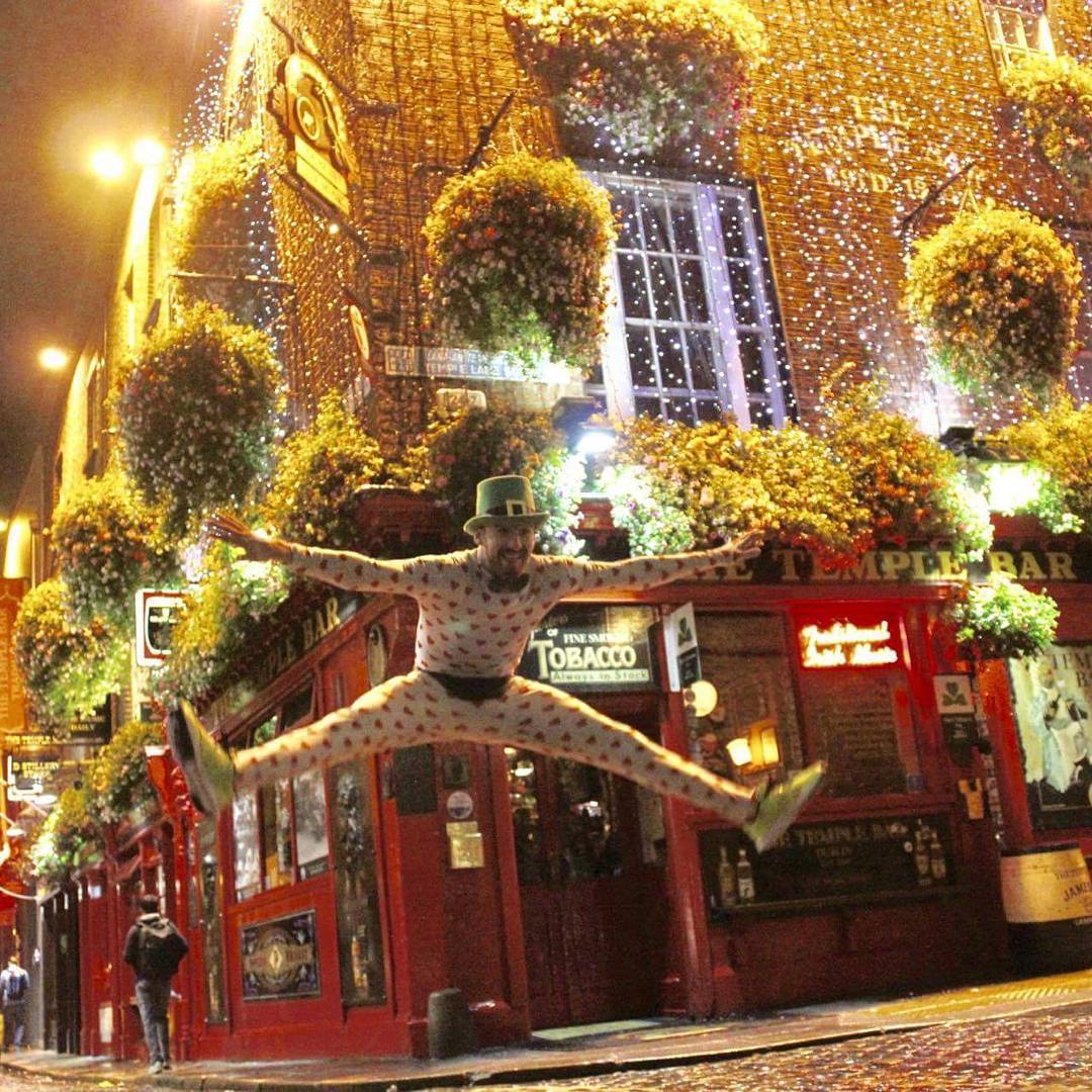 Ludo in the Loveman heart suit, leaping in front of the Temple Bar pub in Dublin at night